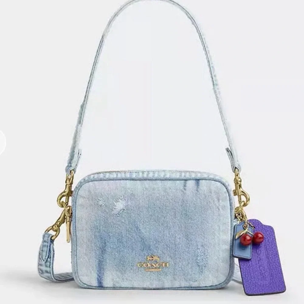 Coach Light Denim Crossbody with Purple Tag and Red Charm